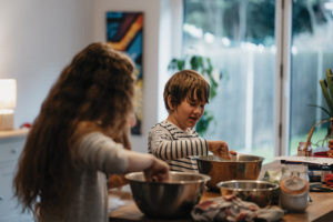 Two 4-H students in a kitchen cooking together