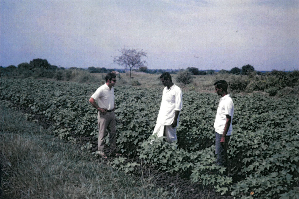 Thomas Lederer talking to farmers in a field