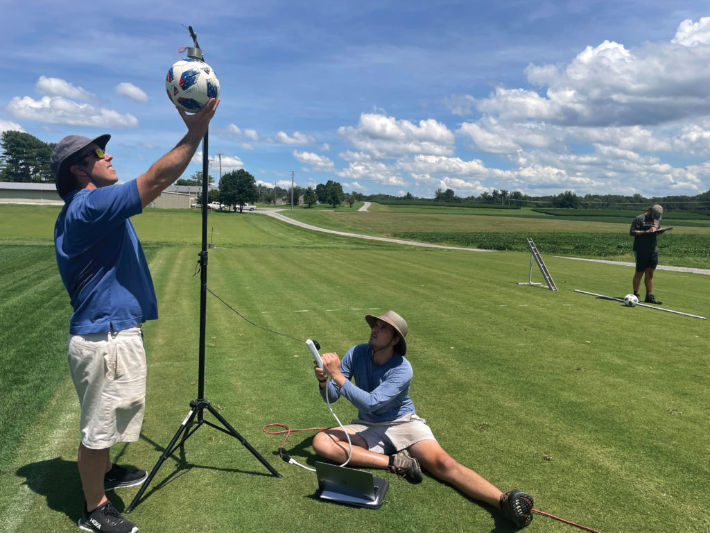 UT turfgrass team members Kyley Dickson, left, and John Thomas evaluate soccer ball bounce and ball roll