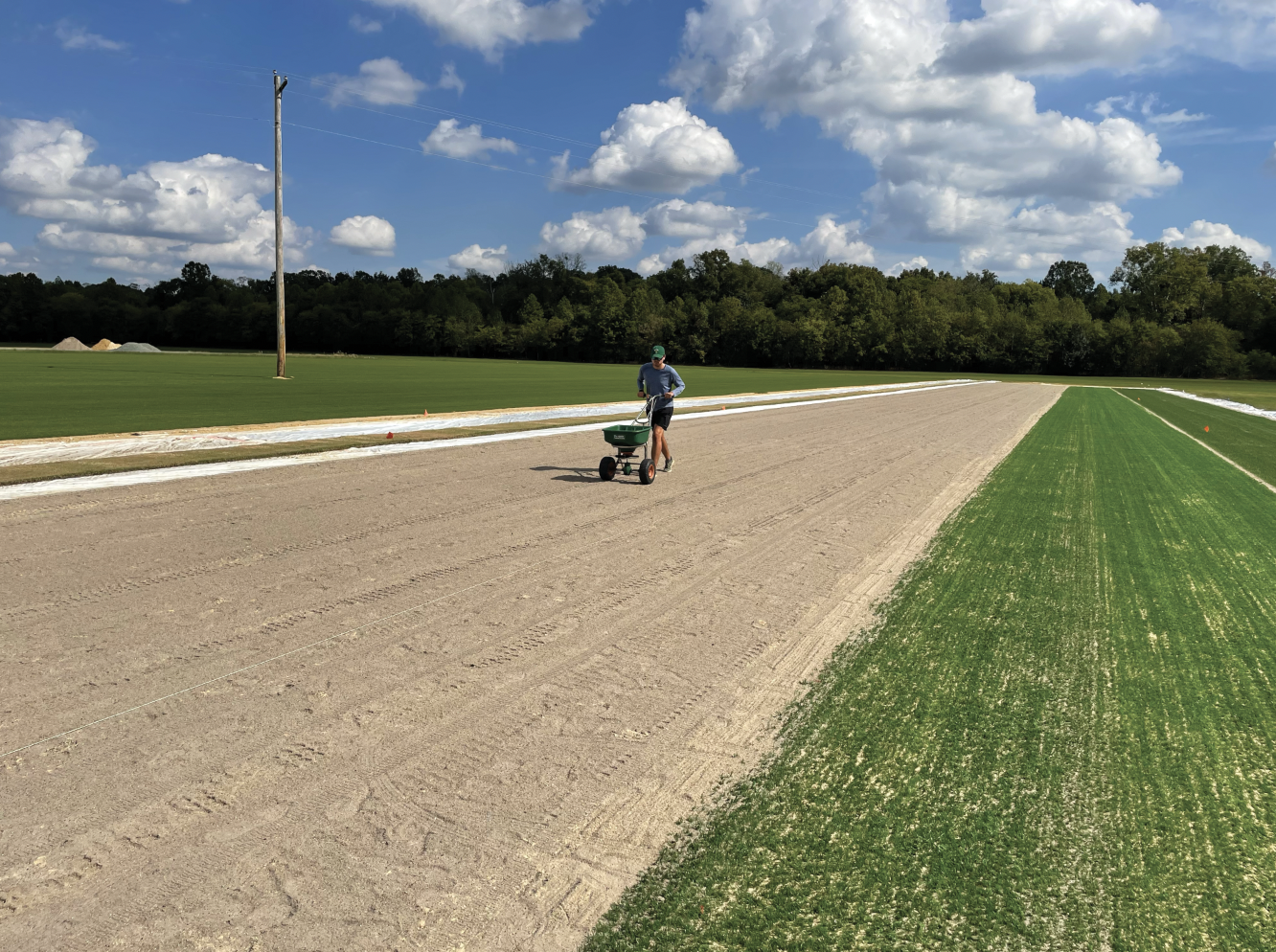 A student fertilizing sod