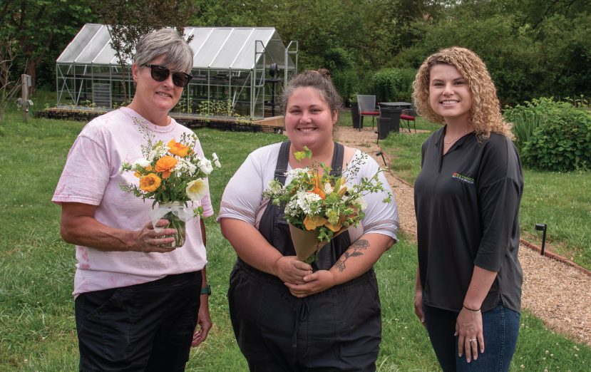 An Extension specialist with two flower producers