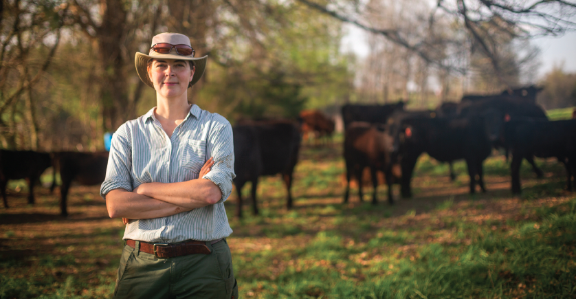 Wyn Miller standing on their family farm with cattle in the background