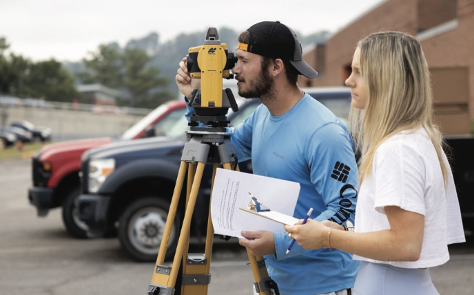 Construction science students using a total station