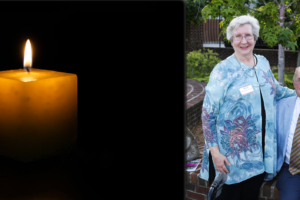 A candle lit with a photo of Joe Johnson with Ruth Henderson McQueen