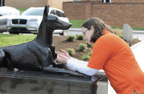 Kate Stanford examining War Dog Memorial 