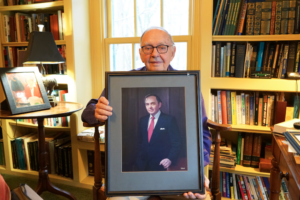 Emmett Barker holding a portrait of himself