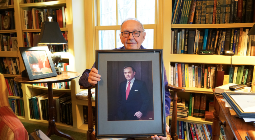 Emmett Barker holding a portrait of himself