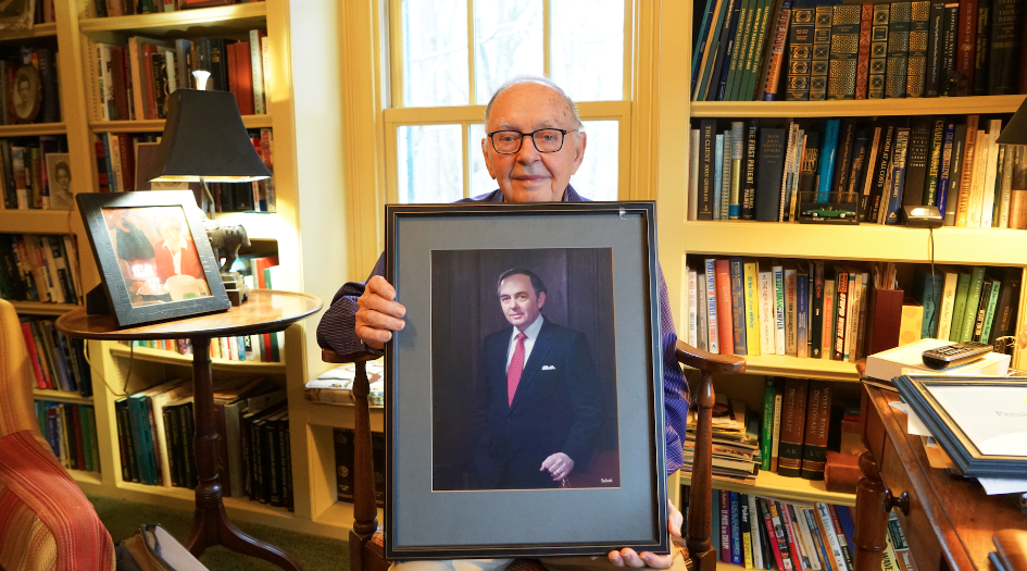 Emmett Barker holding a portrait of himself