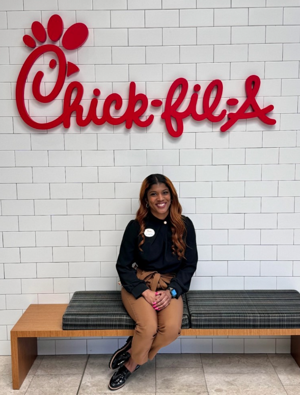 Jacinda Dunn sitting under a Chick-fil-A sign