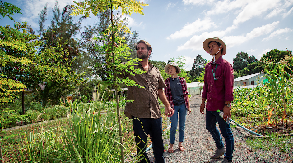 Dave Ader examining a tree with students