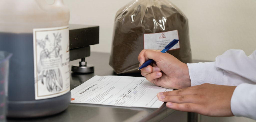 A student filling out measurement paperwork for ice cream production