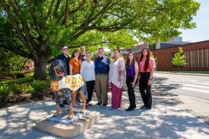 A group standing with the Smokey Statue