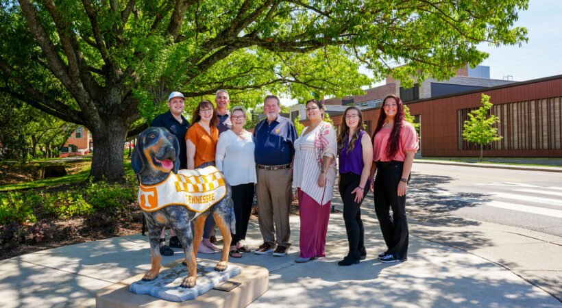 A group standing with the Smokey Statue