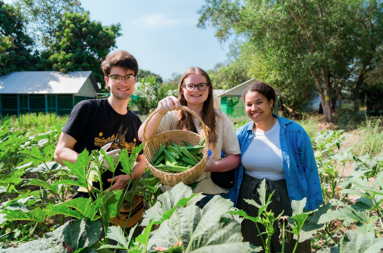 Students holding a basket of harvested produce