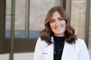 Molly Brinkmann in a white lab coat