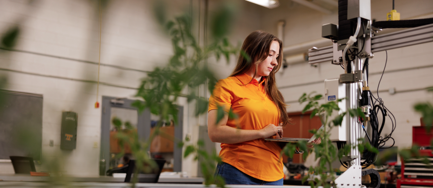 Student working with a farm bot