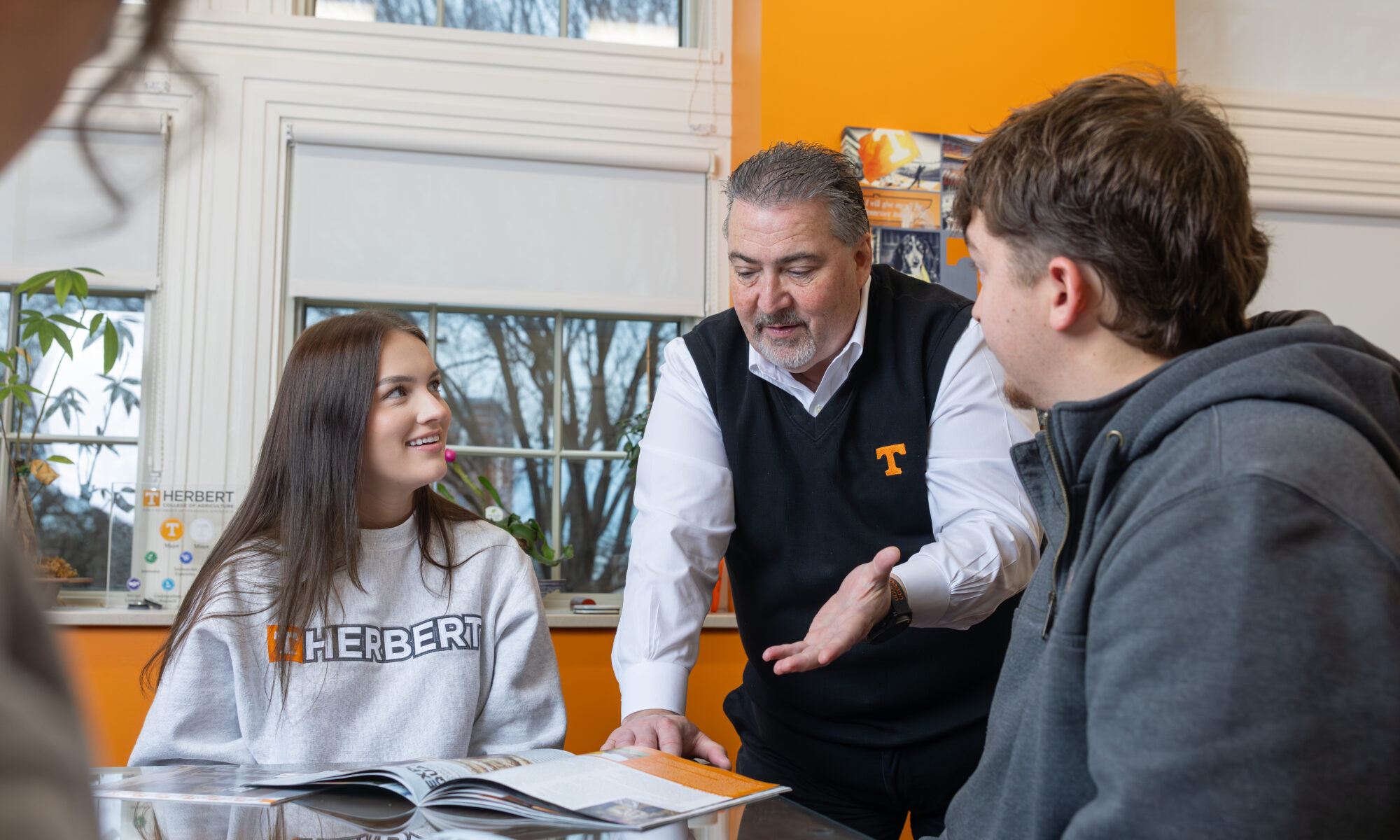 A dean talking with two students