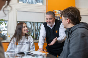 A dean talking with two students