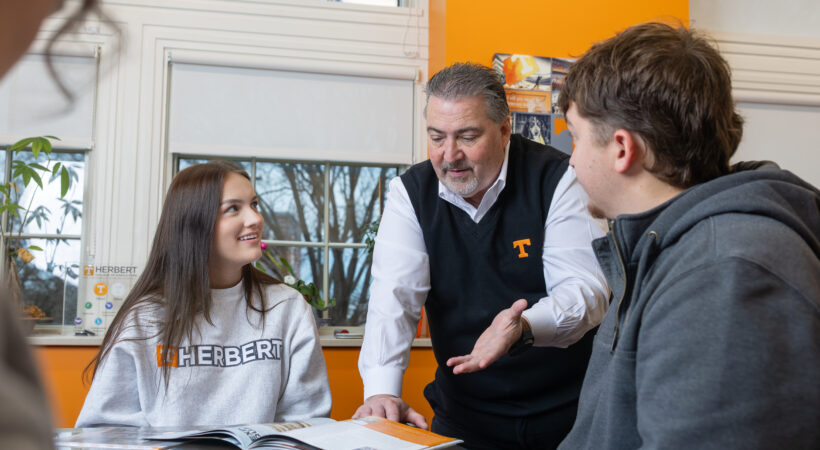 A dean talking with two students
