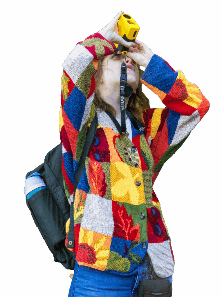 A students looking up using a laser that measures tree height