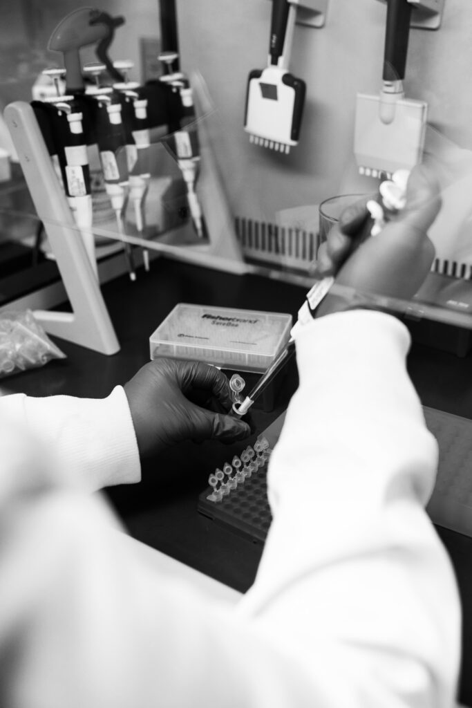 A person in a lab using a pipet