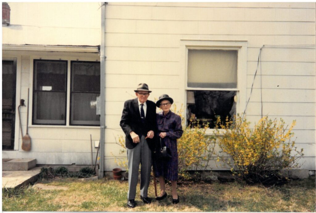 A couple standing in front of building