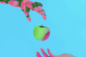 A robot arm handing an apple to a human hand