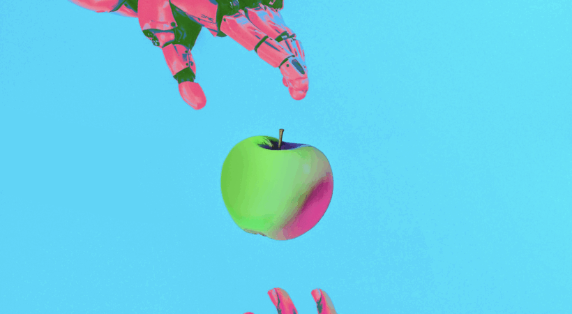 A robot arm handing an apple to a human hand