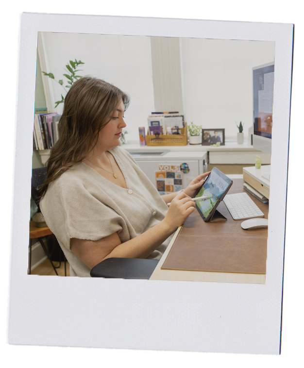 A graphic designer in their office hand-drawing an illustration on an iPad