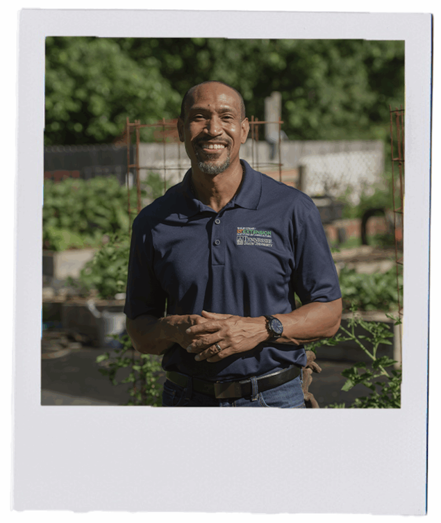 A person standing in front of a large garden
