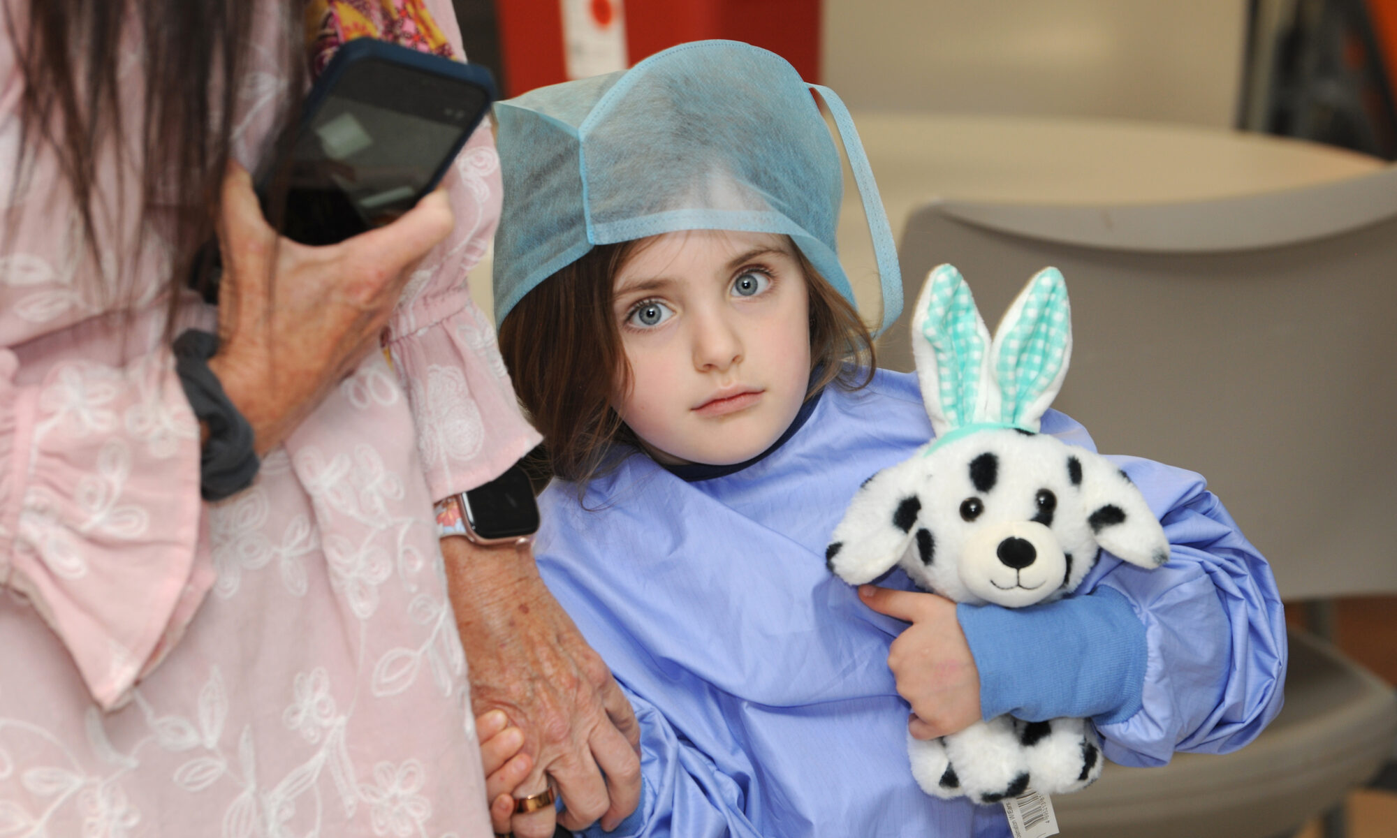 Little girl holding a toy dog