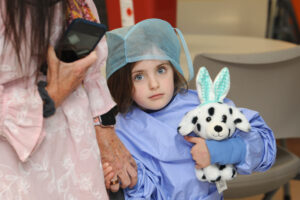Little girl holding a toy dog