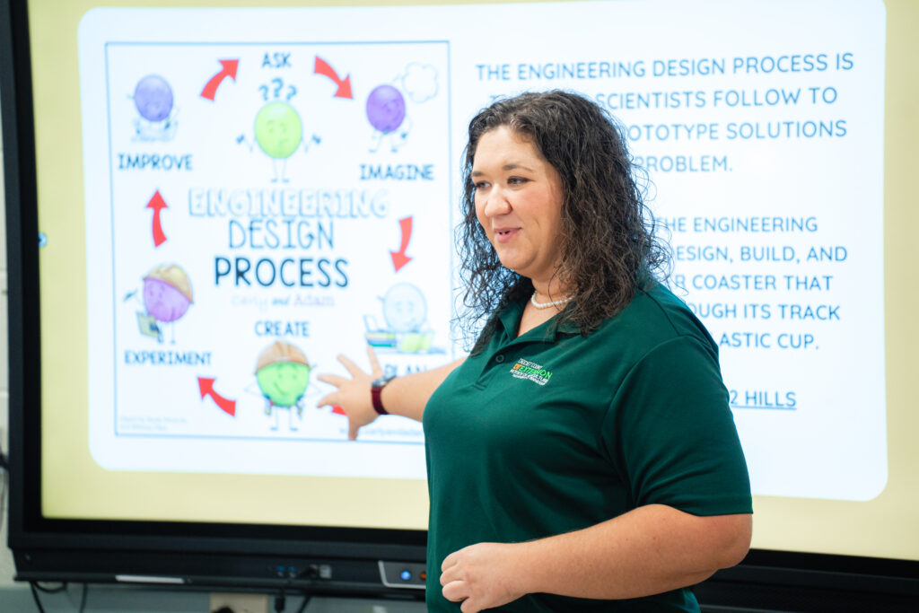 A 4-H extension agent teaching students on the engineering design process